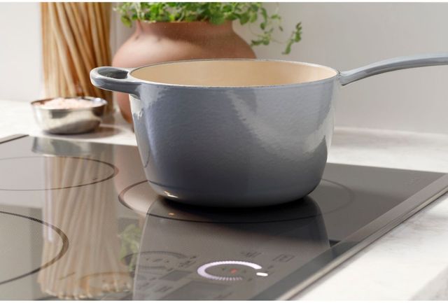 View of a pot cooking on a 36" cafe induction cooktop with touch controls