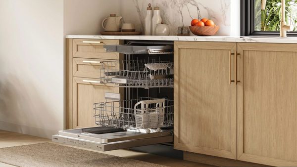 Woman loading dishes into a Bosch dishwasher