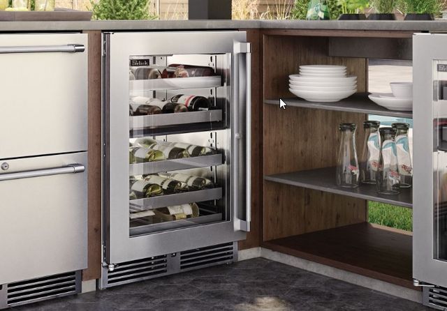 Front view of the Perlick® Signature Series Stainless Steel 24" Dual-Zone Wine Cooler in a built in outdoor kitchen.