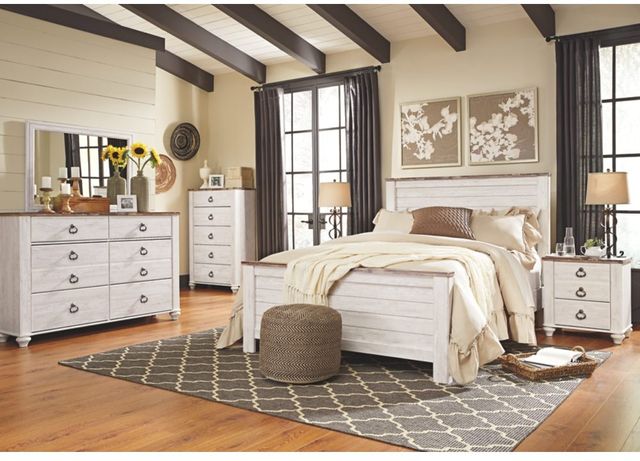 front view of a modern farmhouse bedroom with white wood furniture including a bed and nightstand
