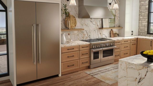Front view of a luxury kitchen with a JennAir refrigerator and induction range