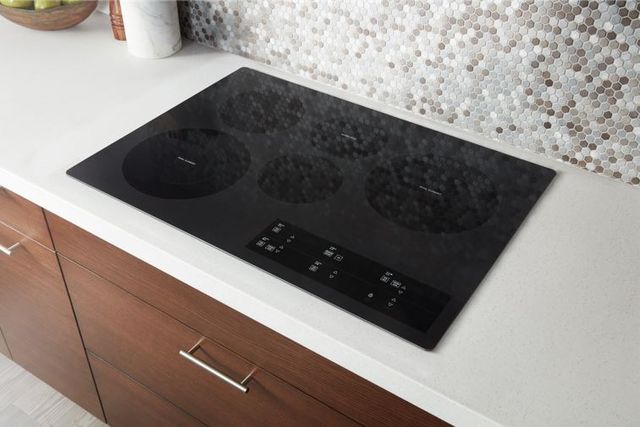Front view of a Whirlpool 30 inch electric cooktop in a modern kitchen