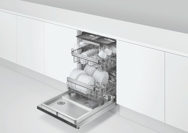 Front view of a white kitchen cabinet with a built in and opened Fisher & Paykel dishwasher