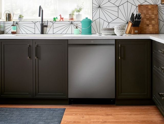 Front view of a modern kitchen with dark cabinets and a grey stainless steel dishwasher