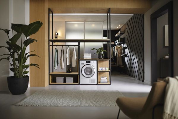 front view of a white heat pump dryer in a modern laundry space