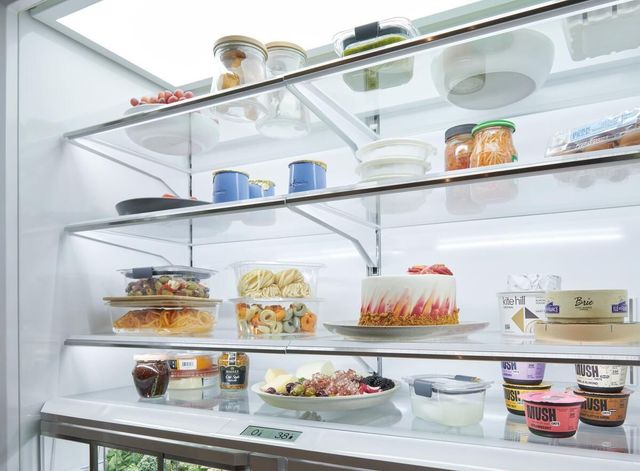Close view of the inside of a Sub-Zero 48" refrigerator with food inside.