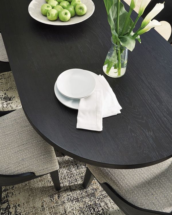 A dining table layered with a rug and runner A dining table layered with a rug and runner