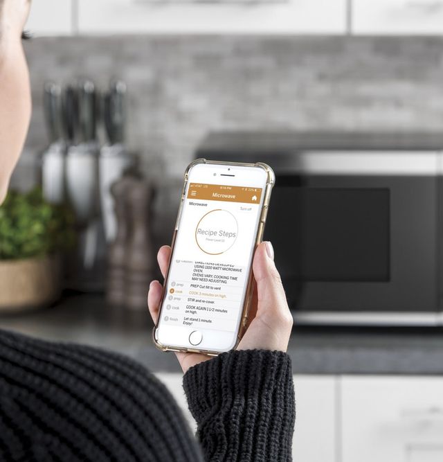 Close view of someone using the GE connected apps to cook with their microwave Close view of someone using the GE connected apps to cook with their microwave