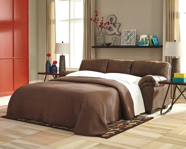 front view of a brown leather sofa bed pulled out in a transitional living room
