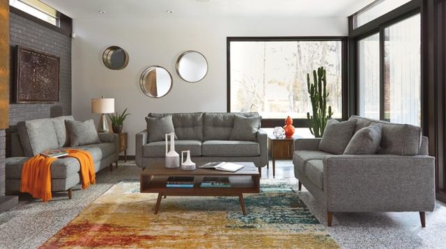 Living room with brown sectional and rustic coffee table