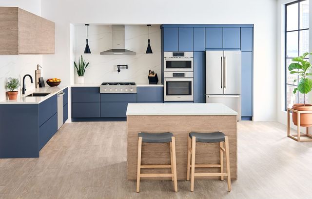 Front view of a modern kitchen with Bosch stainless steel appliances including a double wall oven and microwave combo