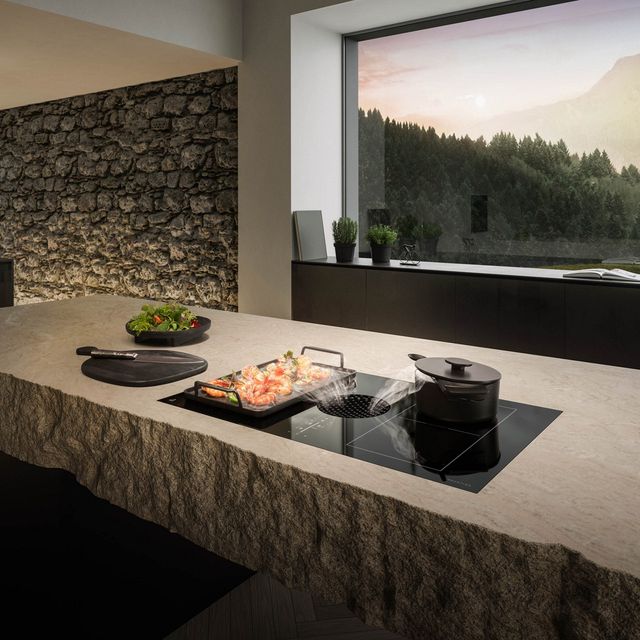 Credit: JennAir Front view of a modern kitchen with a JennAir downdraft induction cooktop