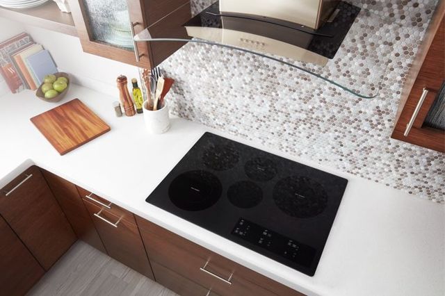 Electric cooktop showcasing illuminated burner zones