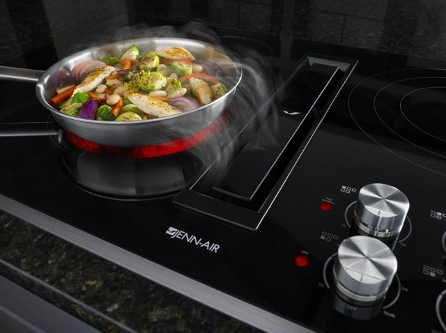 front view of stir fry cooking on a Jenn Air downdraft cooktop