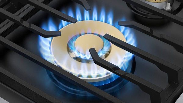 Close up view of the control knobs on a gas cooktop.