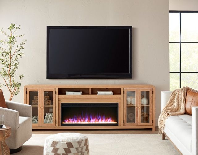 Front view of a wall mounted TV over a modern media console with fireplace