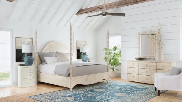 Front view of a modern bedroom with coastal-inspired furniture and a four poster bed