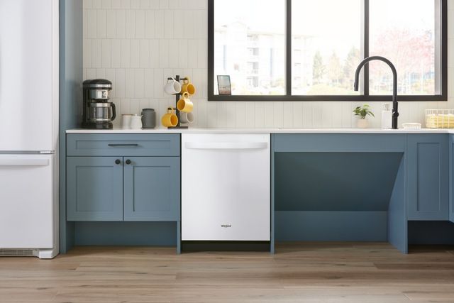 Modern white kitchen featuring a contemporary white dishwasher