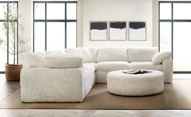 A white sectional sofa in a bright living room A white sectional sofa in a bright living room
