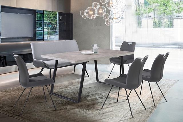 view of a contemporary dining room with a table, bench, and chairs 