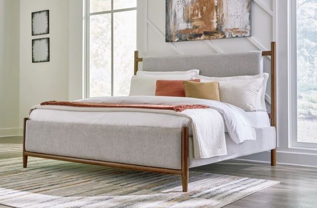 Front view of a modern bedroom with a panel bed and matching furniture Front view of a modern bedroom with a panel bed and matching furniture
