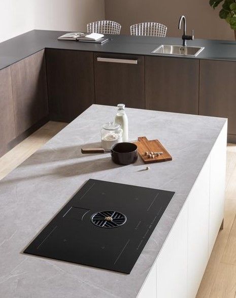 Lifestyle image of a chef cooking on a modern induction surface