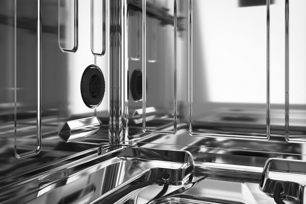 A person loading a quiet dishwasher A person loading a quiet dishwasher