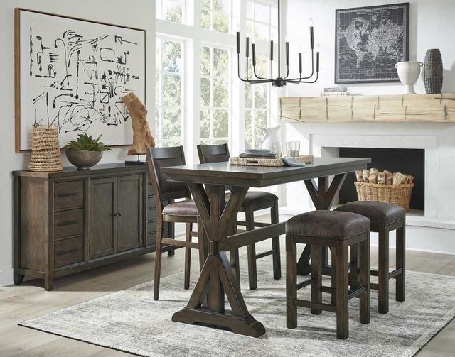 front view of a modern dining room with counter height rectangular table, two chairs on one side and two stools on the other, with a matching sideboard having various decor on top