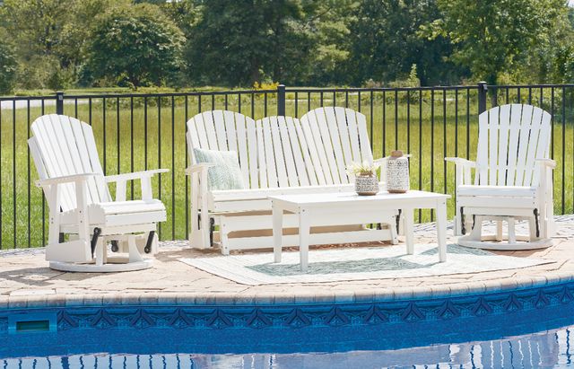 Small patio with two white Adirondack chairs and a small round table between them Small patio with two white Adirondack chairs and a small round table between them