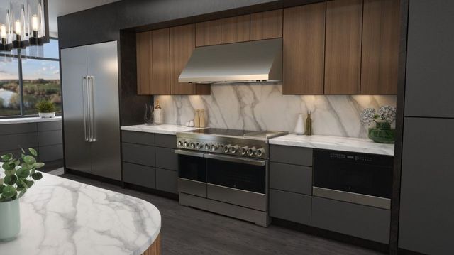 Front view of a luxury kitchen with a JennAir refrigerator and induction range