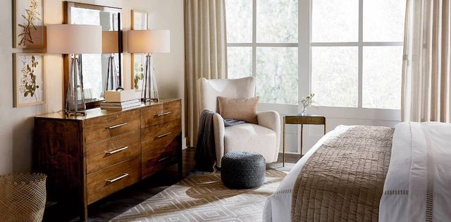 View of a modern bedroom with a modern wooden bedroom dresser