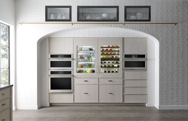 Front view of a wine built in panel ready wine cooler and refrigerator built between two double wall ovens.