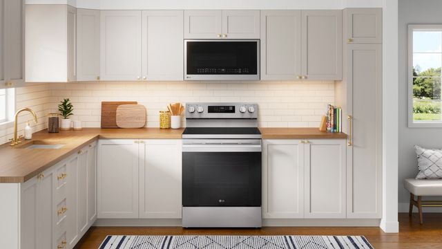 Front view of a modern kitchen with an LG smart electric range and over the range microwave