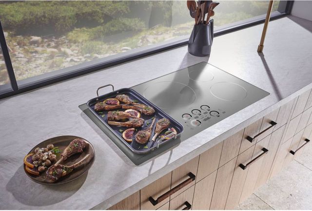 Top view of a pan of lambchops cooking on a Monogram induction cooktop