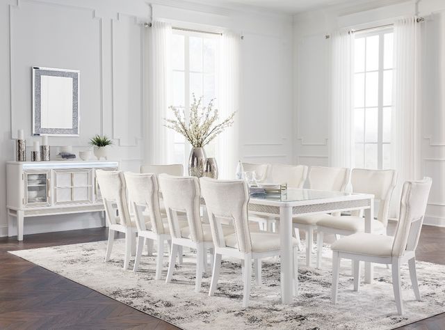 front view of a white dining room with a large rectangular white dining table with 10 seats around it