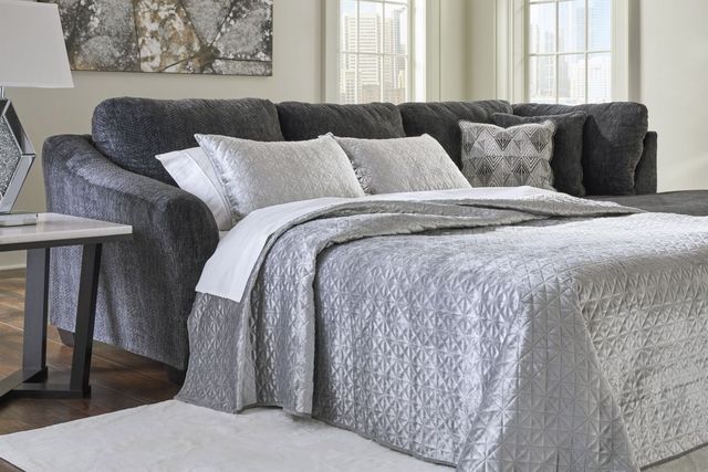 front view of a modern living room with a grey sleeper sectional pulled out