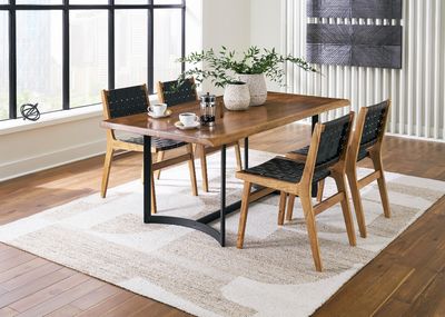 front view of the Signature Design by Ashley® Fortmaine Black/Brown 5 Piece Dining Set in a modern dining room
