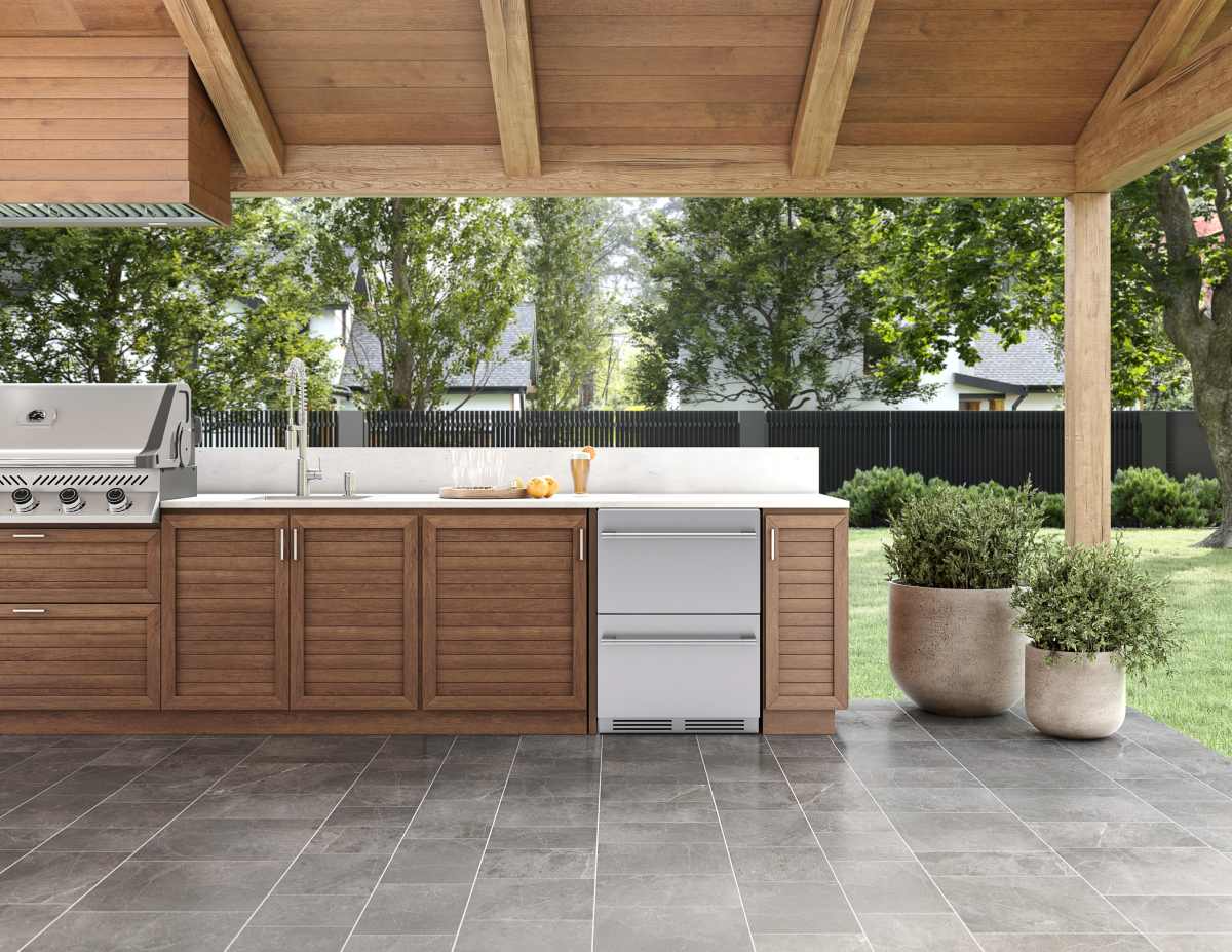 Modern outdoor kitchen featuring a premium stainless steel refrigerator