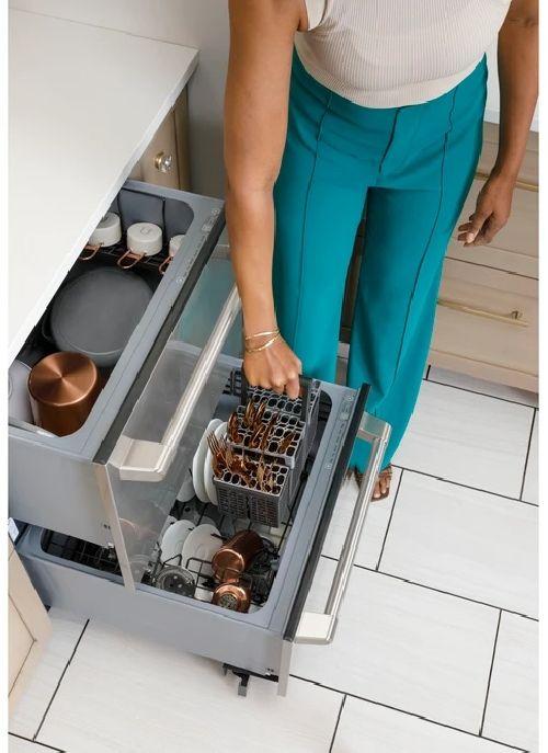A drawer dishwasher being installed in a kitchen A drawer dishwasher being installed in a kitchen
