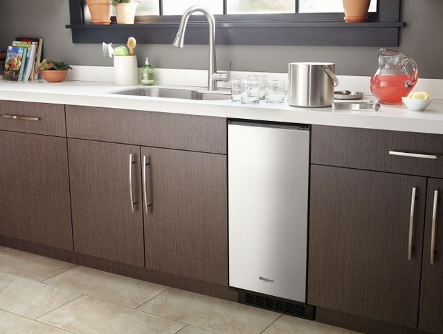 Front view of a Whirlpool under counter ice maker in a modern kitchen