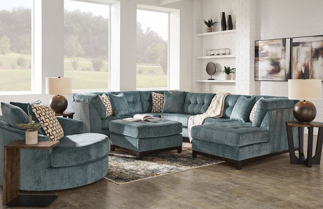 Credit: Signature Design by Ashley Front view of a large section and oversized chair in a casual living room