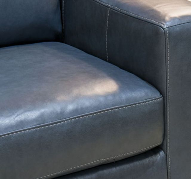 Close view of faux blue leather on a modern sofa sleeper from Ashley Furniture
