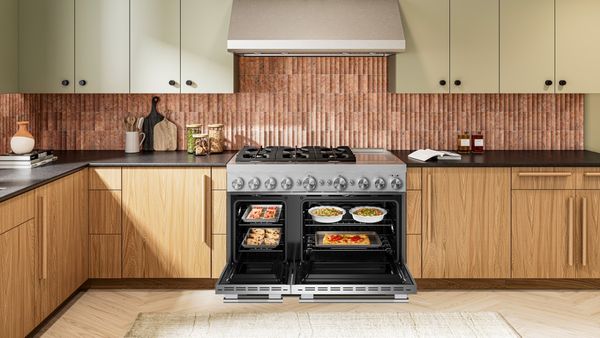 A KitchenAid stove with food cooking on the stovetop A KitchenAid stove with food cooking on the stovetop