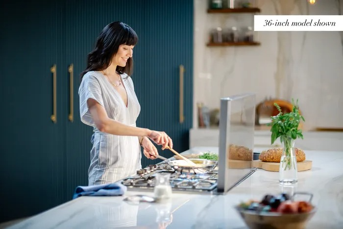 Sleek kitchen island featuring open sightlines and modern downdraft ventilation