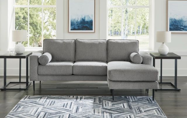 Credit: Signature Design by Ashley Front view of a mid-century modern sofa with matching side tables