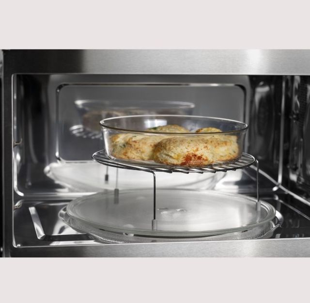 Front view of the inside of a convection microwave cooking chicken