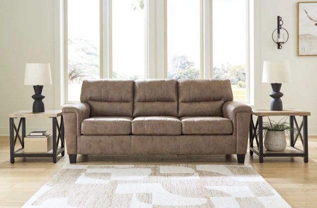 Front view of a modern living room with a faux leather sofa bed