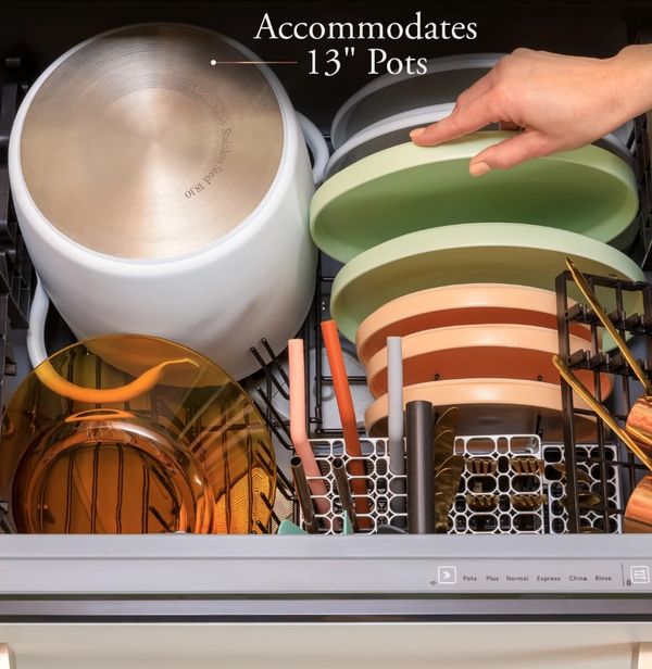 A person loading a drawer dishwasher A person loading a drawer dishwasher