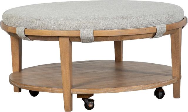 Magnussen Home® Lindon Belgian Wheat/Sauve Pebble Round Cocktail Table with Upholstered Top and Casters-0