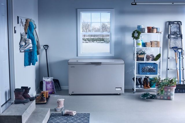 Closed white upright freezer Closed white chest freezer in a cold climate